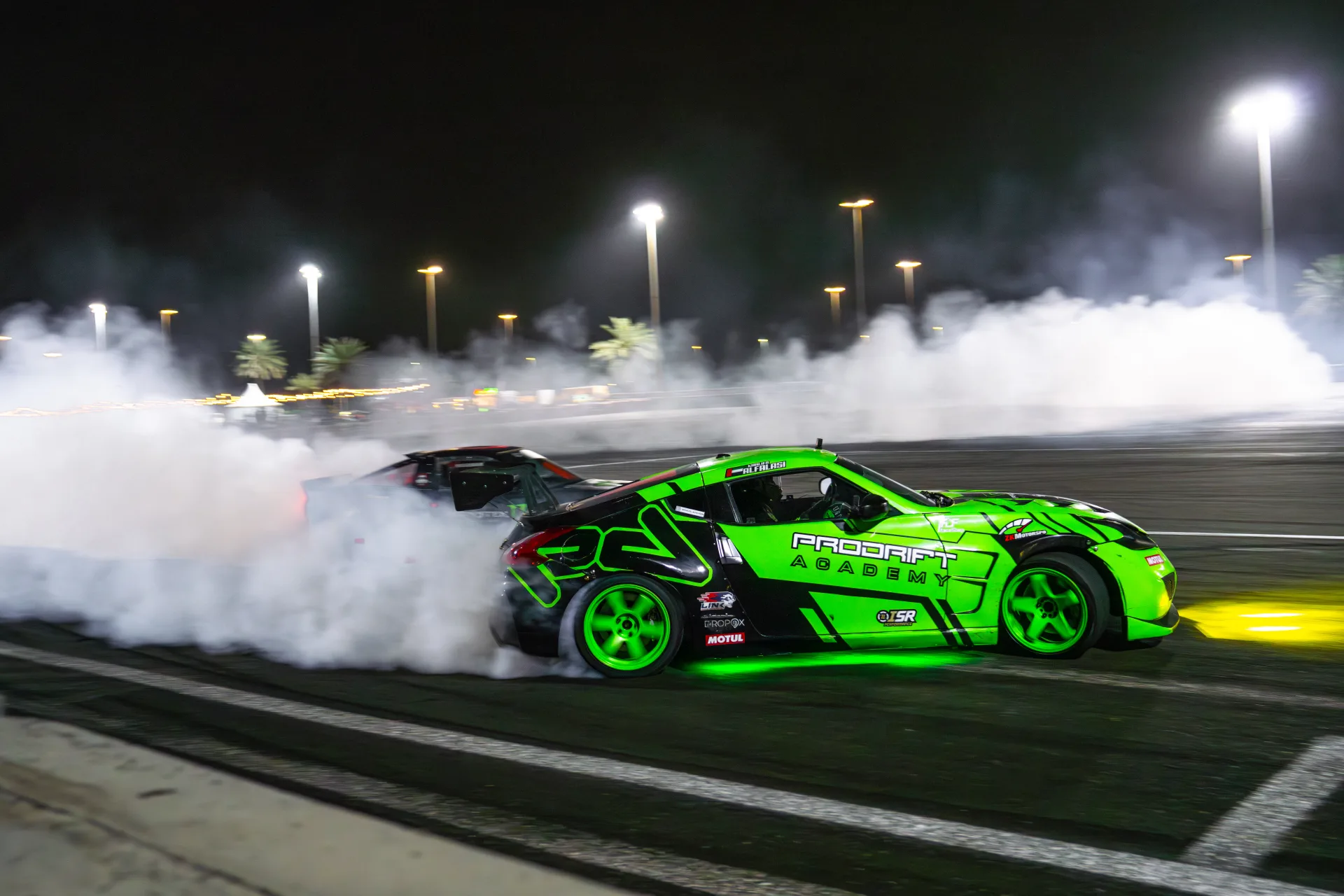 A Prodrift Academy car mid-drift on track, tyre smoke pouring off the rear wheels