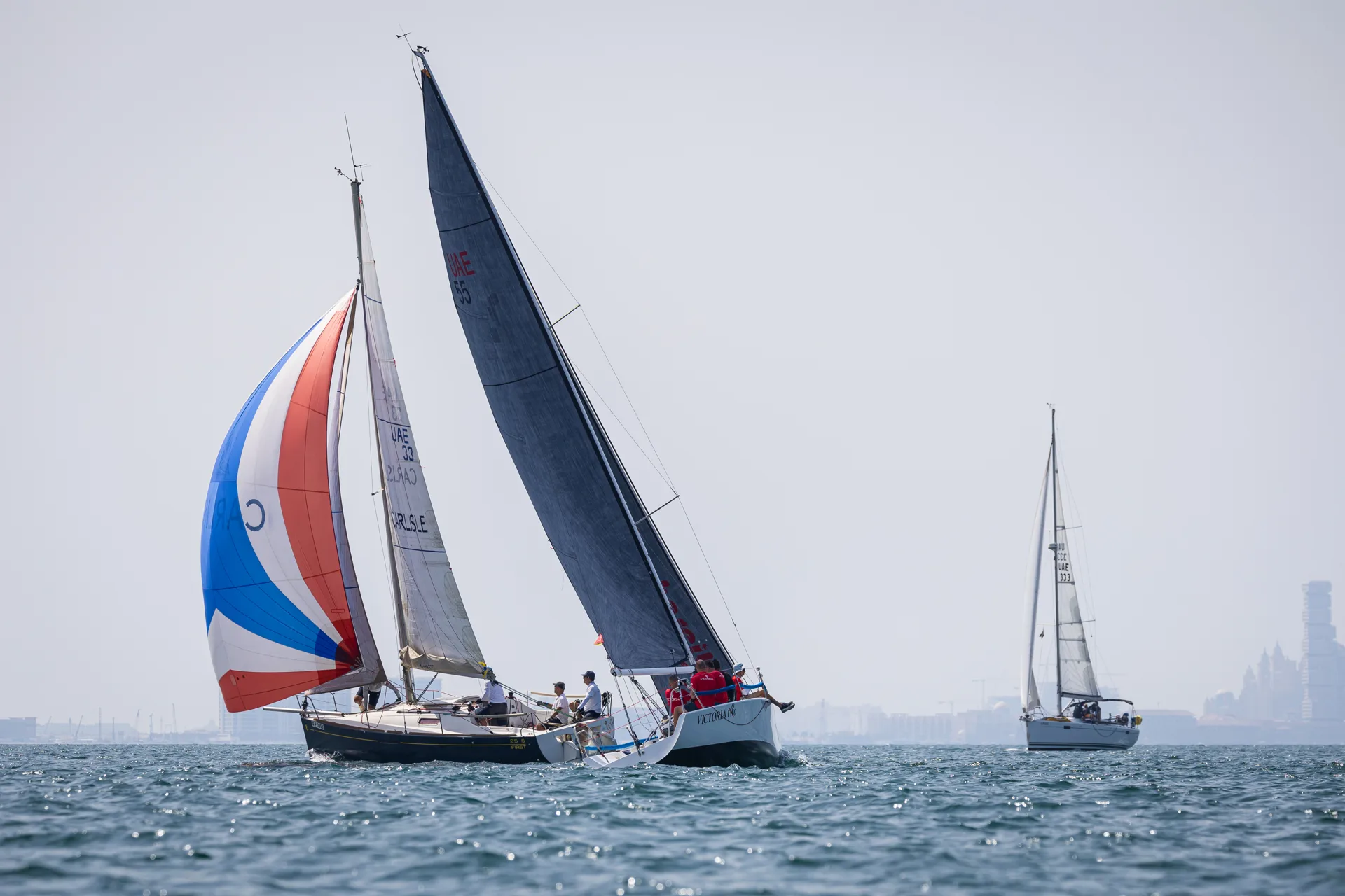 The Victoria Too racing yacht heeling under full sail during a regatta
